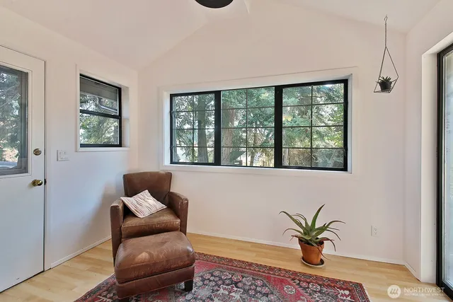 a living room with furniture lamp and window