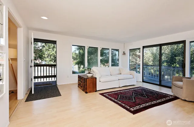 a living room with furniture and a floor to ceiling window