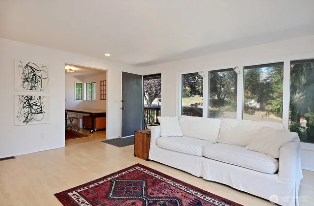 a living room with furniture and large window