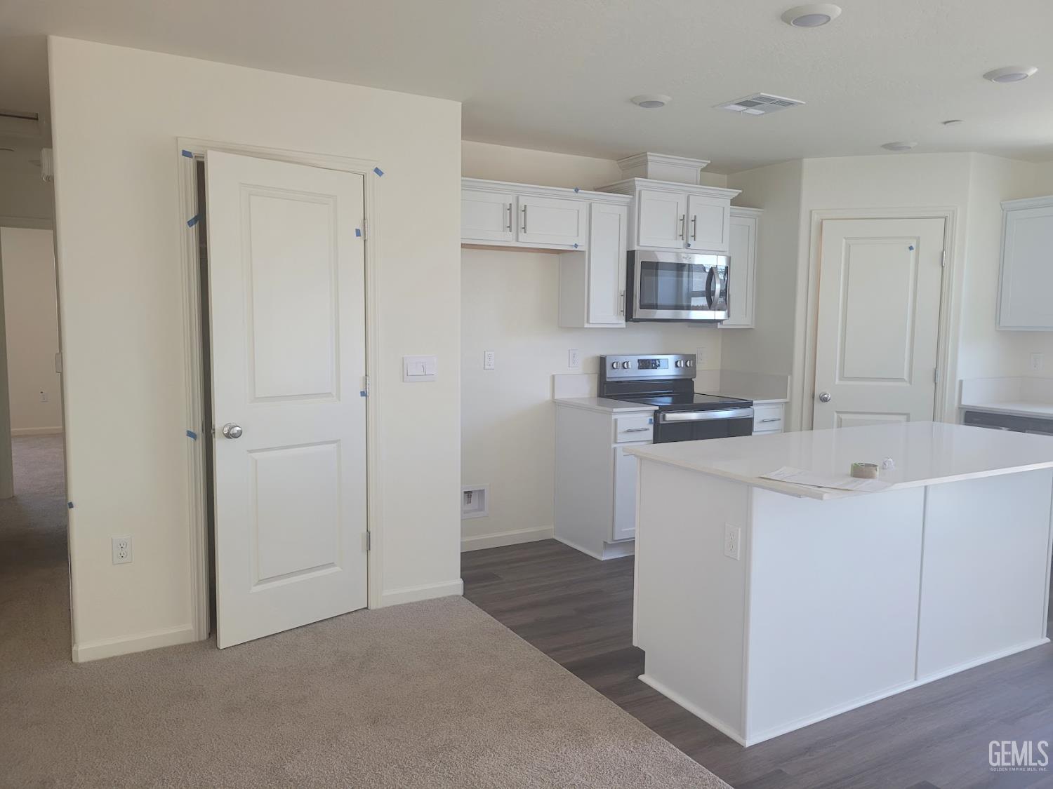 Undisclosed Address Bakersfield, CA 93311 - Photo 7 of 24 a kitchen with kitchen island a sink a stove and refrigerator