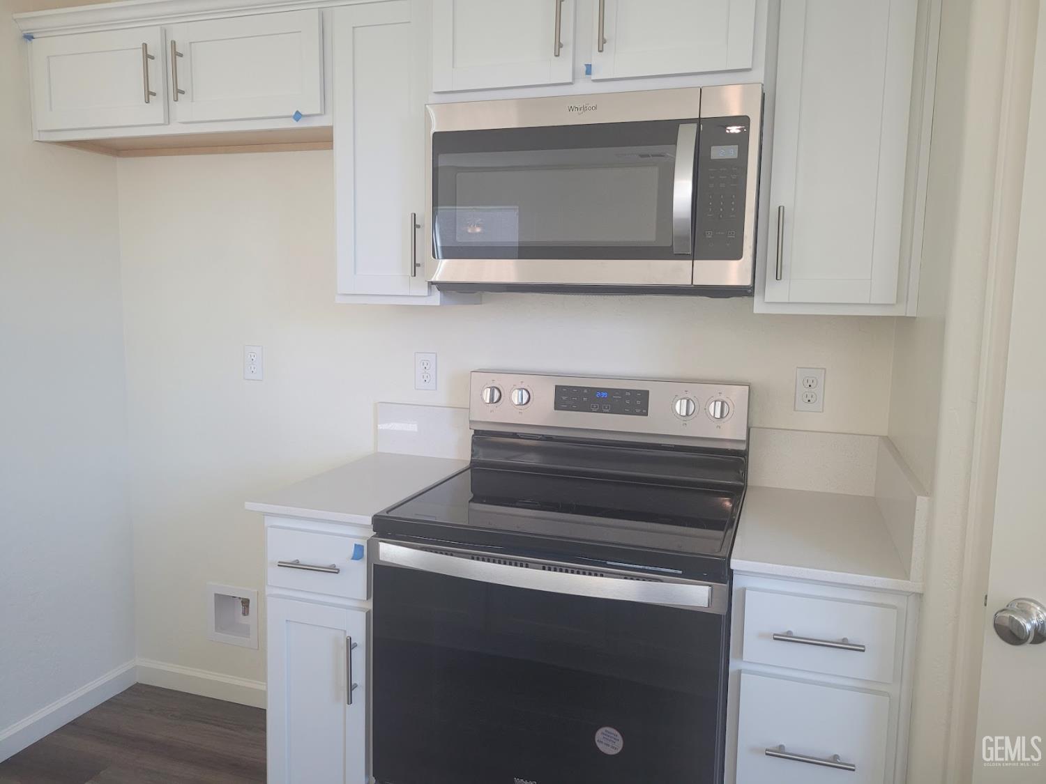 Undisclosed Address Bakersfield, CA 93311 - Photo 8 of 24 a kitchen with a stove and a microwave