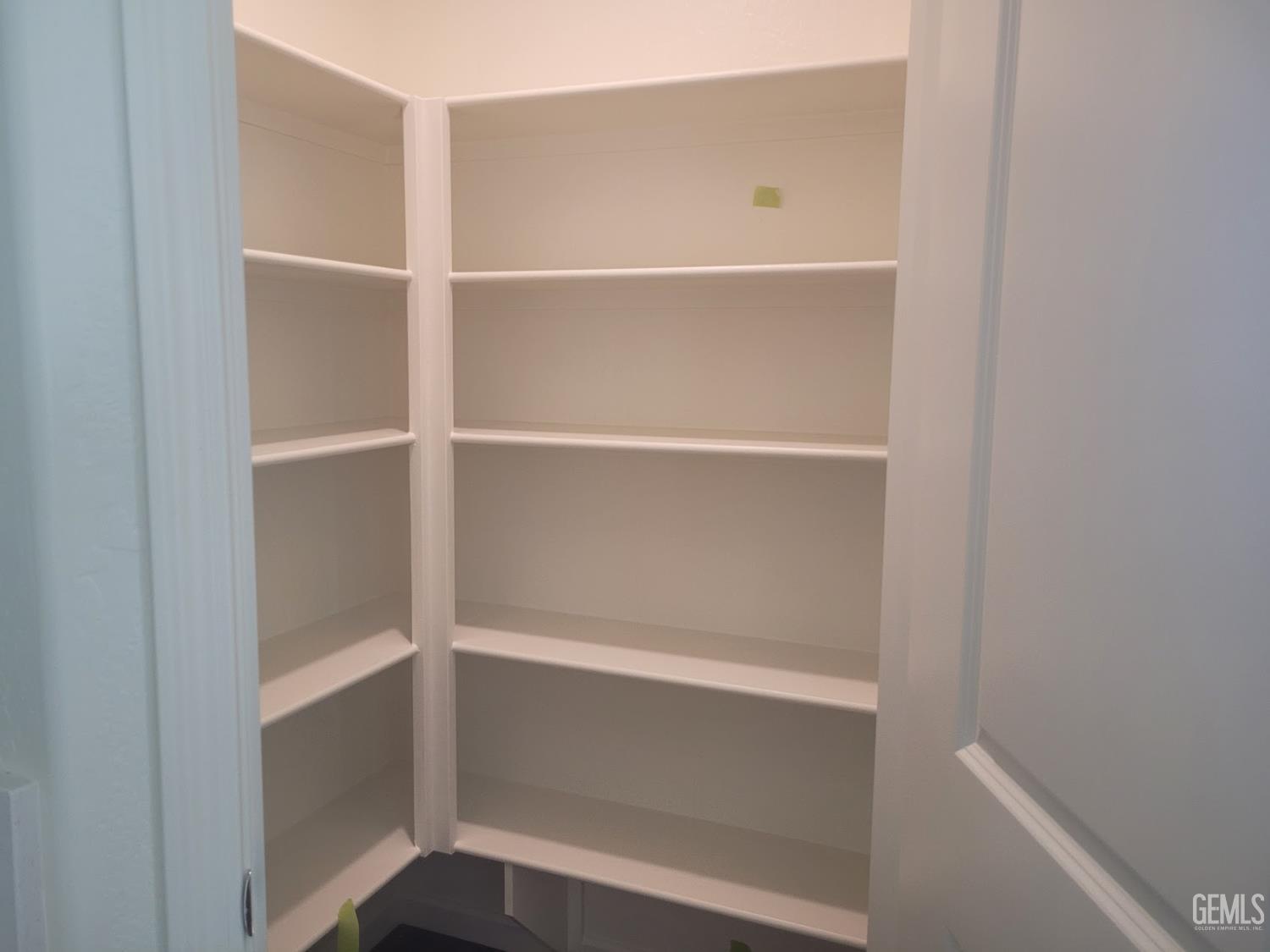 Undisclosed Address Bakersfield, CA 93311 - Photo 9 of 24 a view of walk in closet with empty racks