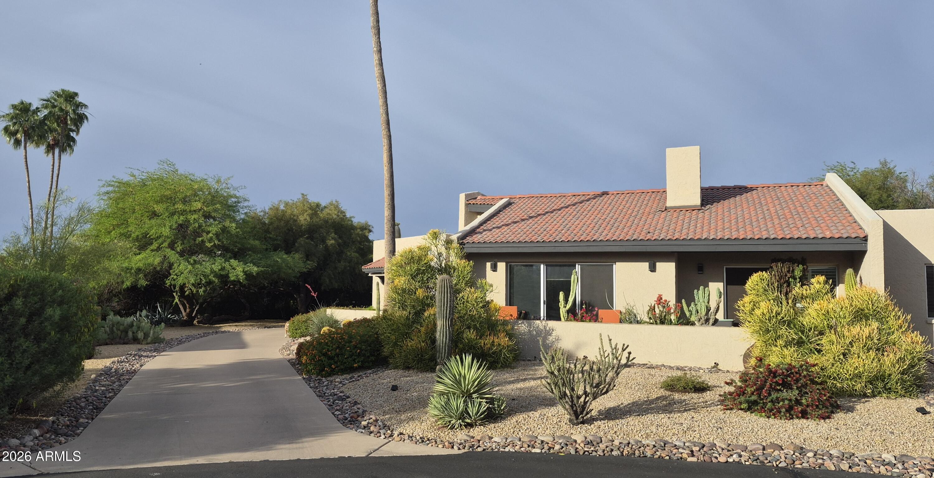 18409 East Horseshoe Bend Rio Verde, AZ 85263 - Photo 1 of 33 a front view of a house with garden