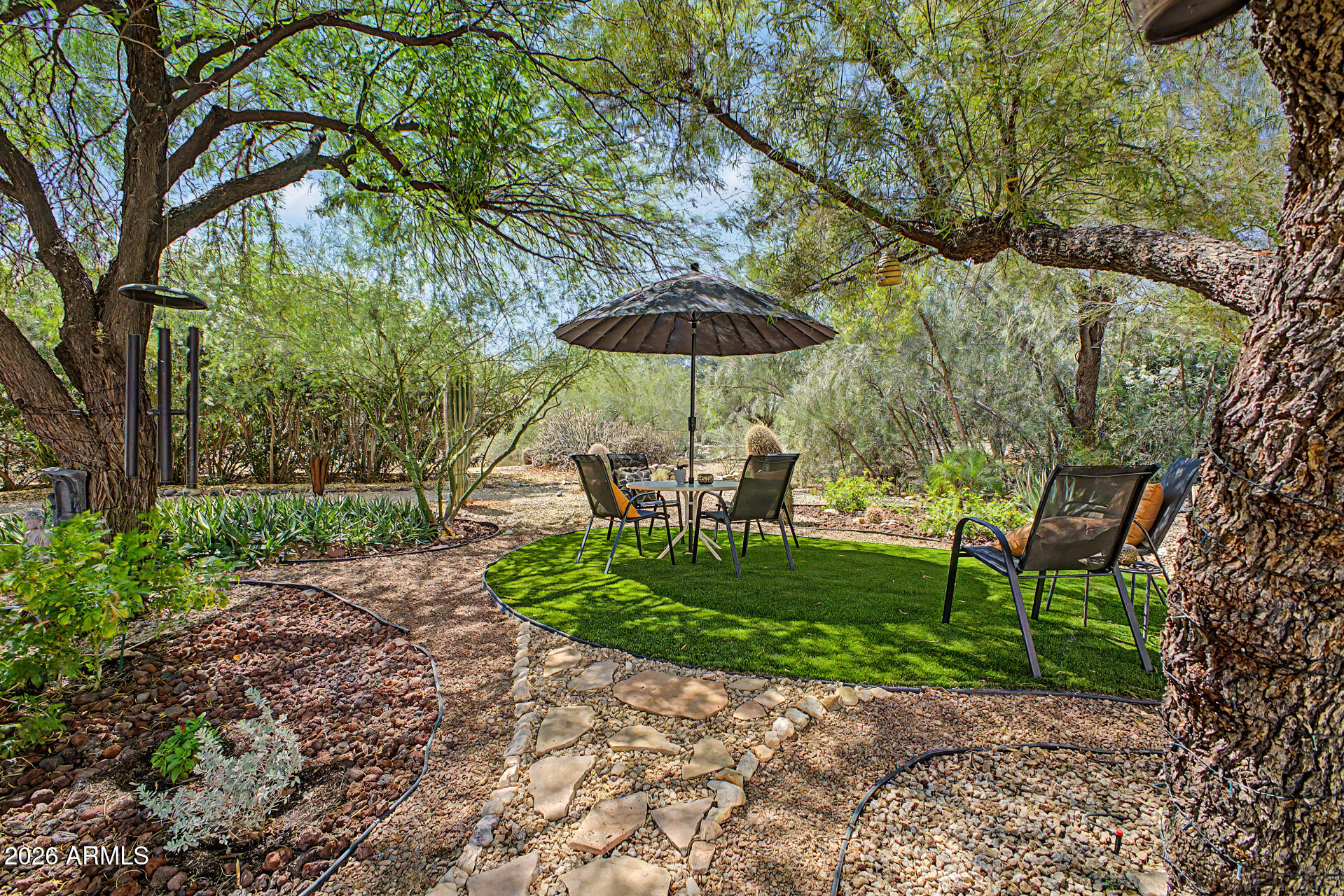 18409 East Horseshoe Bend Rio Verde, AZ 85263 - Photo 27 of 33 a view of a backyard with table and chairs under an umbrella