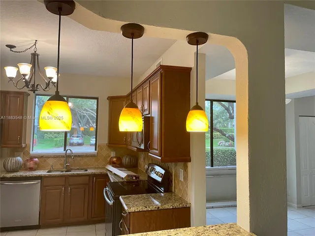 a view of a kitchen with a sink and living room