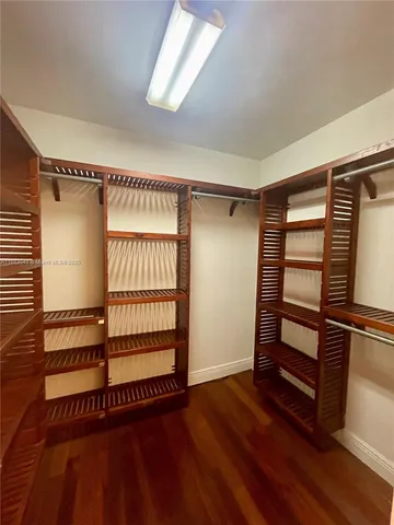 a view of a room with wooden floor and windows