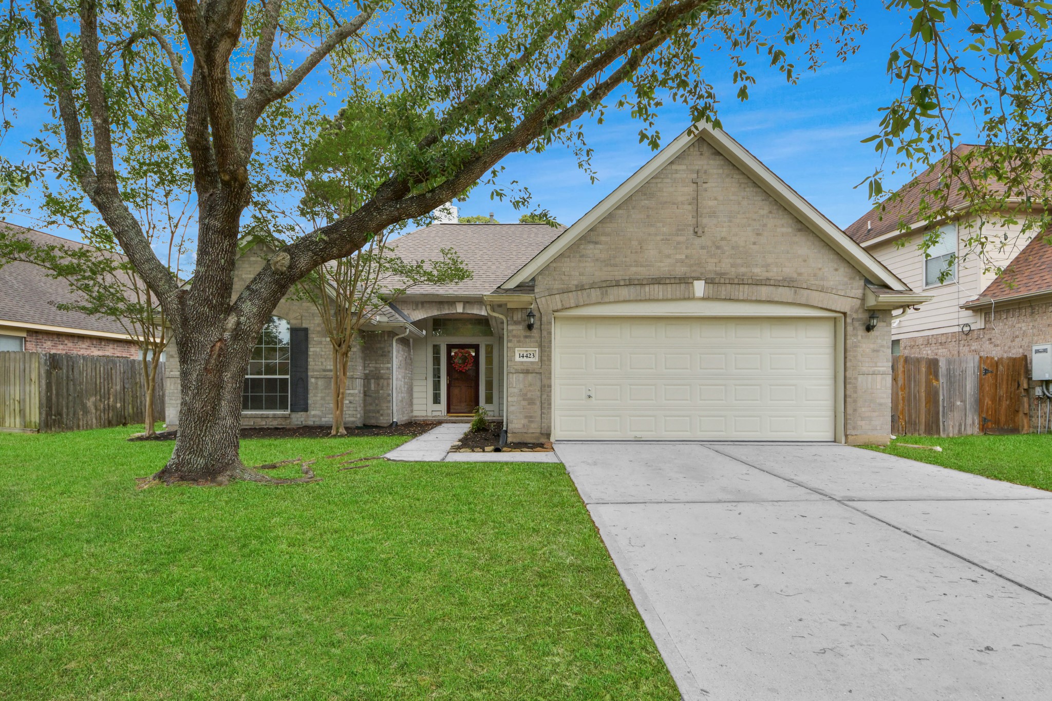 14423 Gadwall Court Houston, TX 77044 - Photo 6 of 42 a front view of a house with a yard and trees