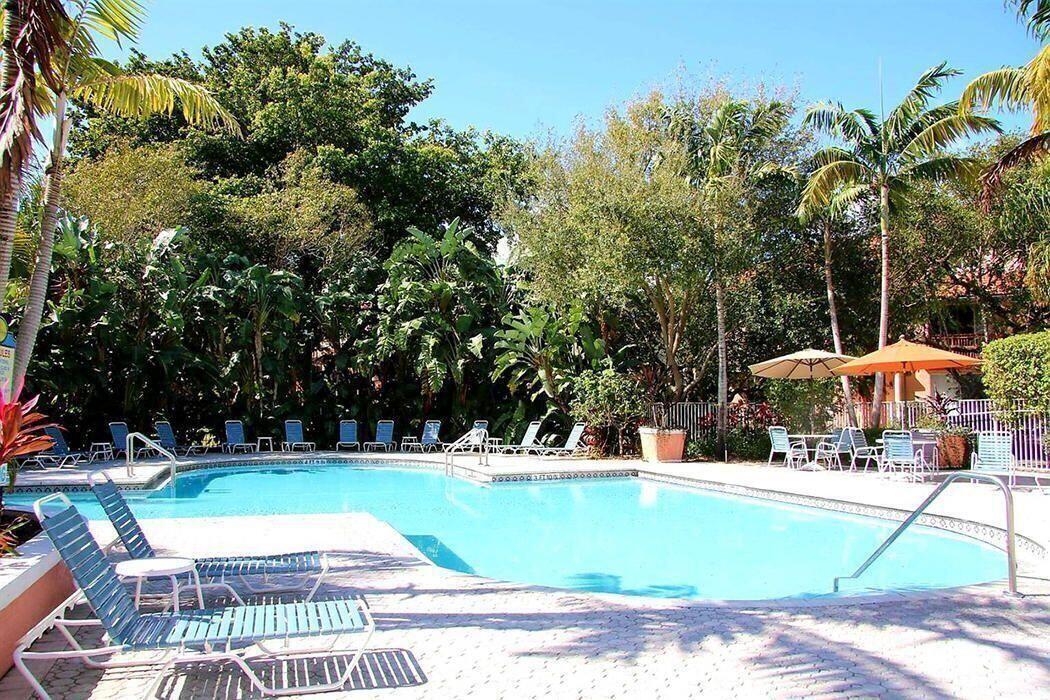 1050 Crystal Way, Unit P Delray Beach, FL 33444 - Photo 13 of 17 a view of a swimming pool with a patio