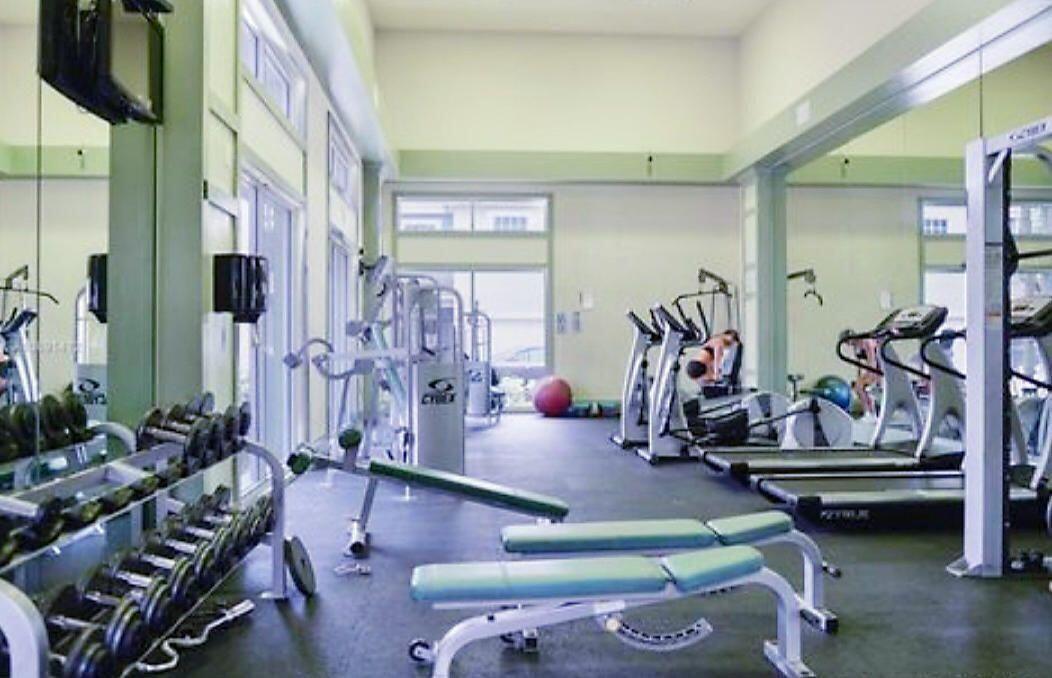 1050 Crystal Way, Unit P Delray Beach, FL 33444 - Photo 15 of 17 a room with lots of gym equipment