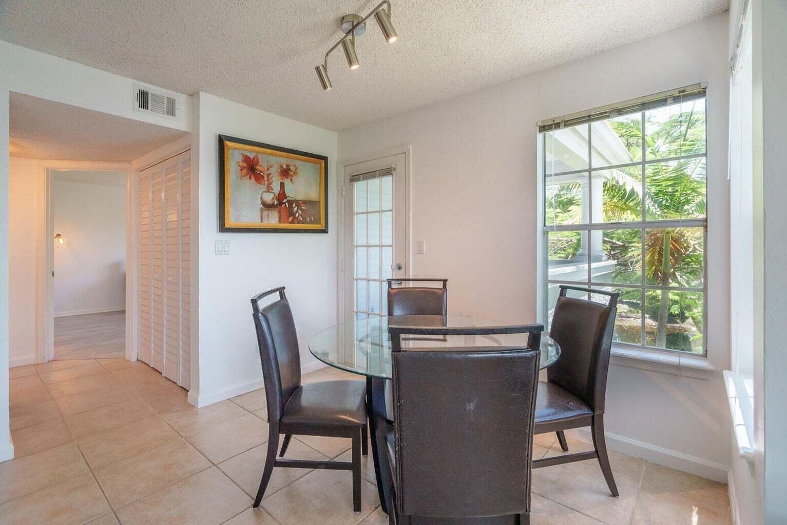 1050 Crystal Way, Unit P Delray Beach, FL 33444 - Photo 6 of 17 a dining room with furniture and window