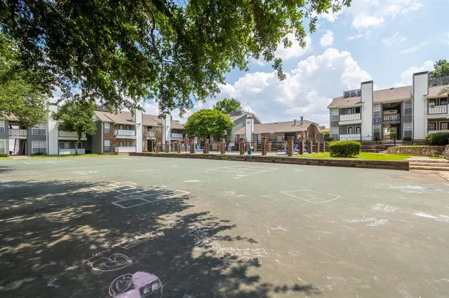 a view of a city street lined with buildings and trees