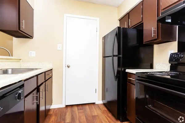 a kitchen with metallic refrigerator and a sink