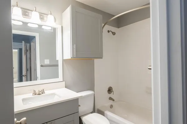 a bathroom with a sink toilet tub and shower