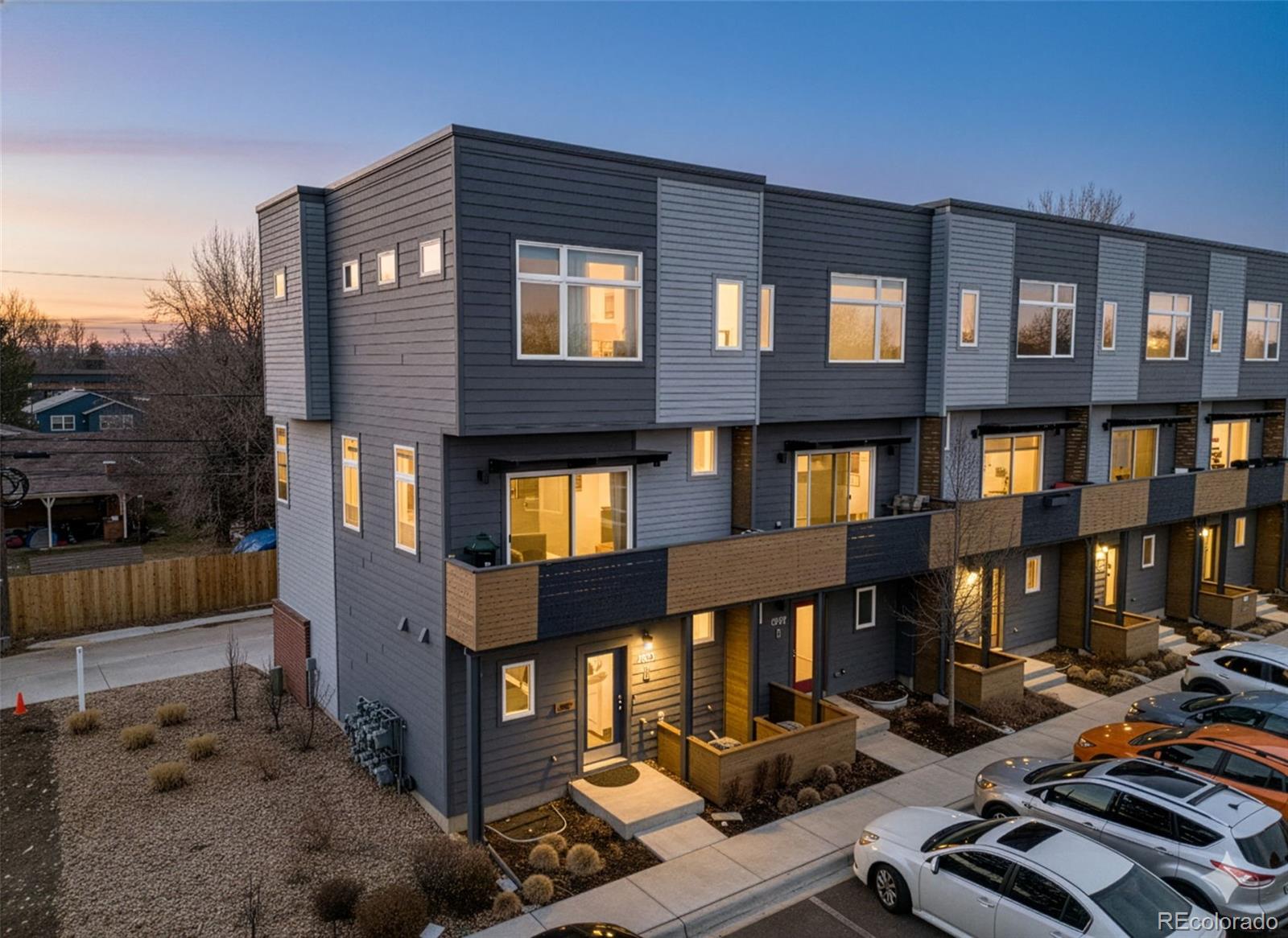 a front view of a residential apartment building with a yard