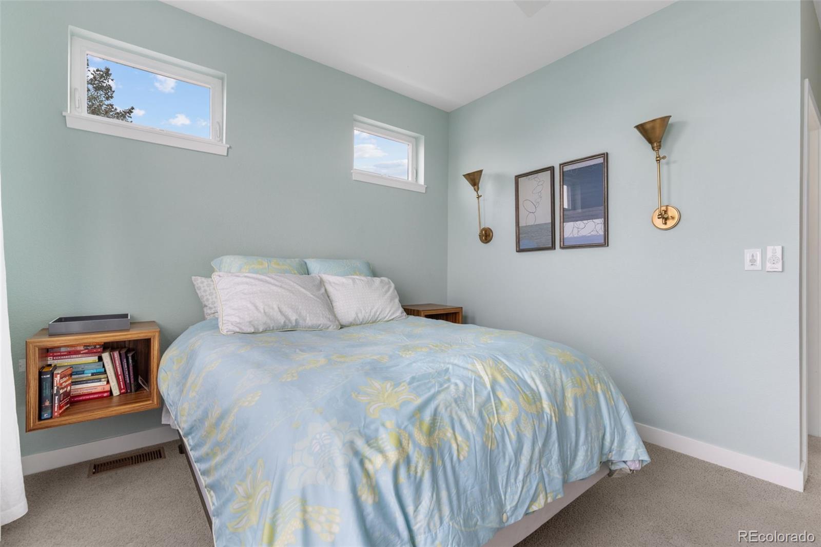 402 West Baseline Road, Unit H Lafayette, CO 80026 - Photo 16 of 37 a bedroom with a bed and a painting on the wall