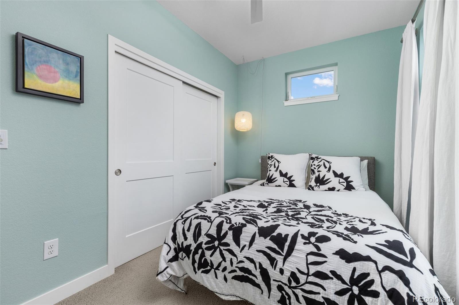 402 West Baseline Road, Unit H Lafayette, CO 80026 - Photo 20 of 37 a bedroom with a large bed and a painting on the wall