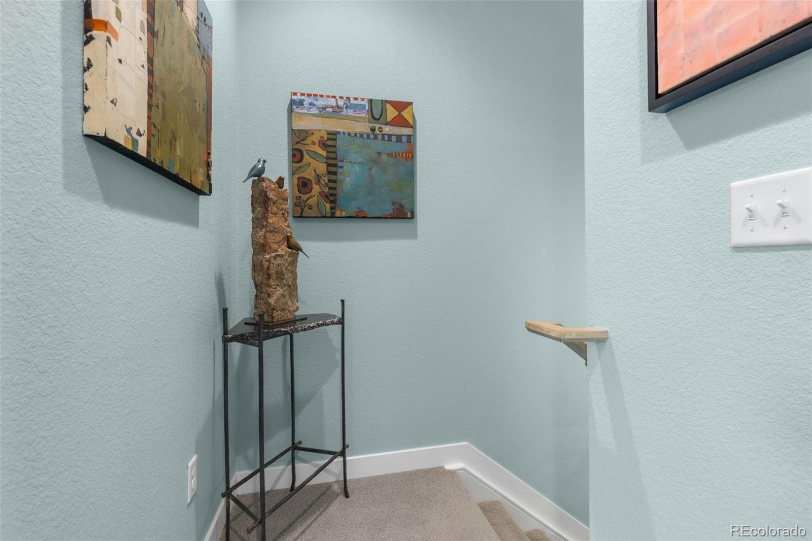 402 West Baseline Road, Unit H Lafayette, CO 80026 - Photo 22 of 37 a view of a hallway with paintings on the wall