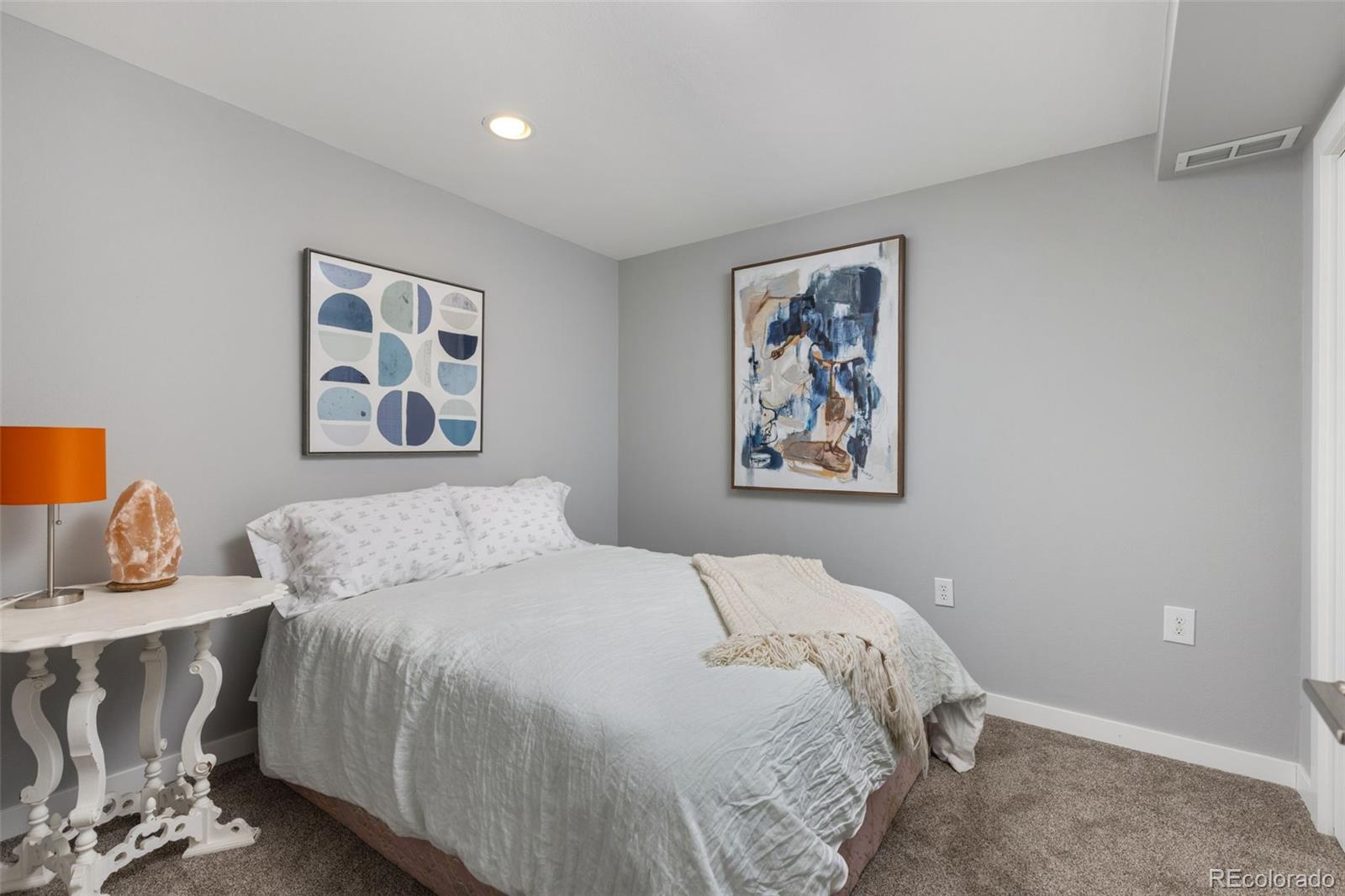 402 West Baseline Road, Unit H Lafayette, CO 80026 - Photo 25 of 37 a bedroom with a bed and painting on the wall