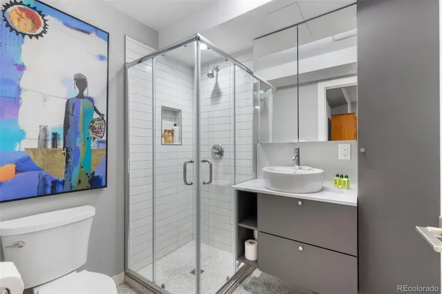 a bathroom with a sink toilet and shower