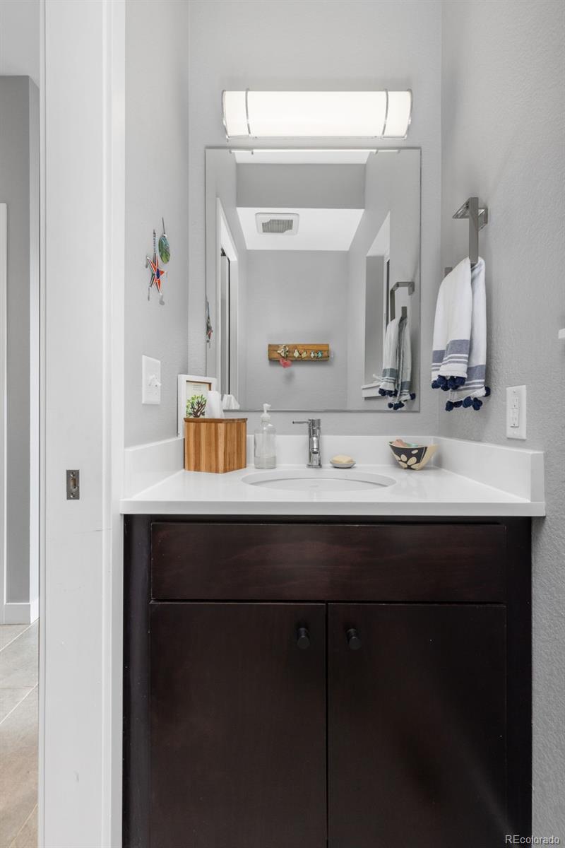 402 West Baseline Road, Unit H Lafayette, CO 80026 - Photo 27 of 37 a bathroom with a sink and a mirror