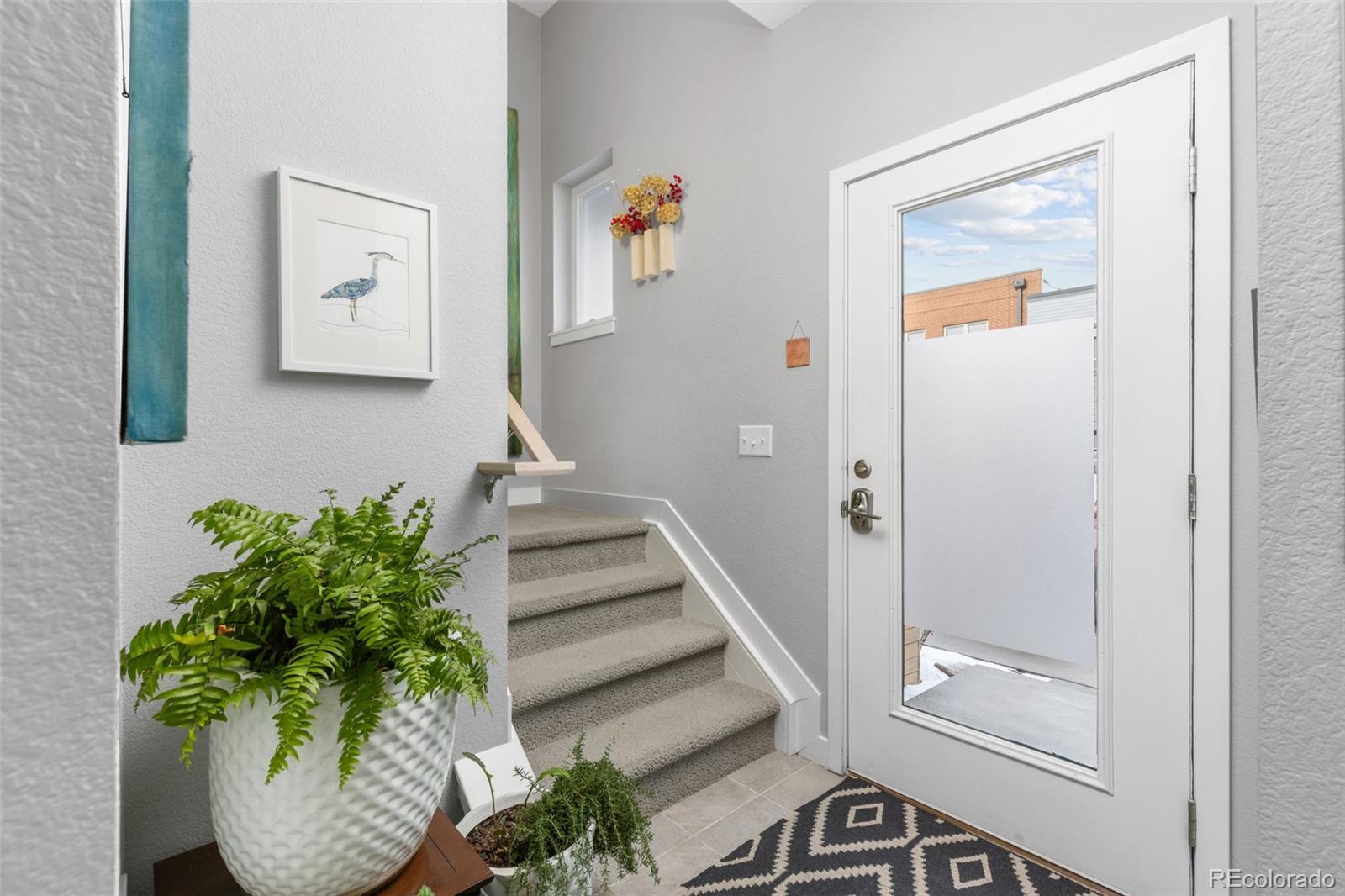 402 West Baseline Road, Unit H Lafayette, CO 80026 - Photo 28 of 37 a view of a hallway with wooden floor and paintings on the wall