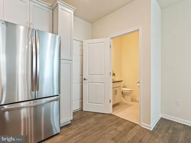 a view of a refrigerator in kitchen and wooden floor