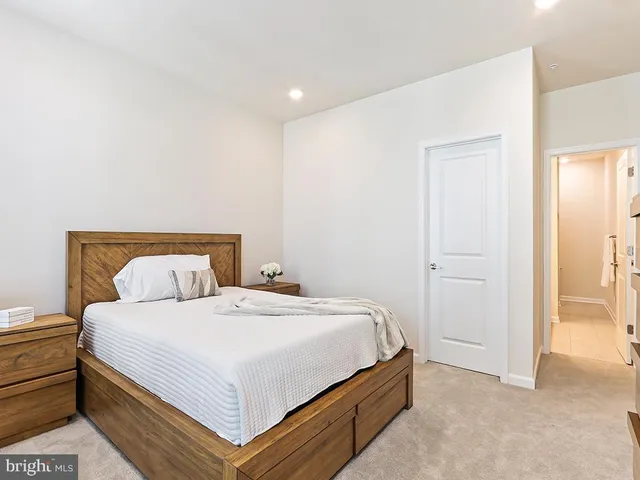 a bedroom with a bed and a night stand