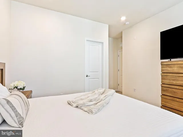 a bedroom with a bed and a flat screen tv