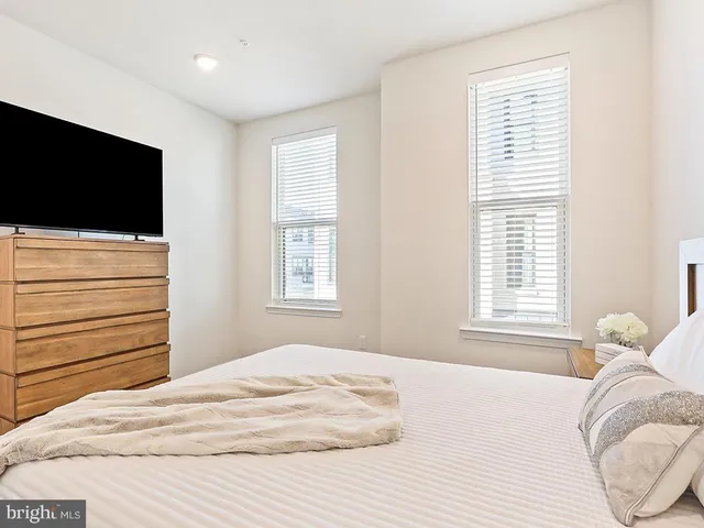 a bedroom with a bed and a television