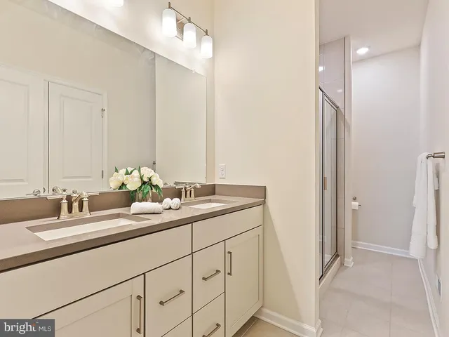 a bathroom with a double vanity sink and a mirror