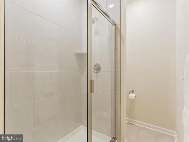 a bathroom with a glass shower door