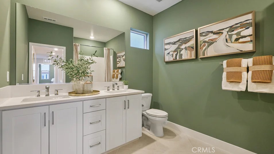 1022 Currant Road Fullerton, CA 92833 - Photo 13 of 25 a bathroom with a toilet sink and mirror
