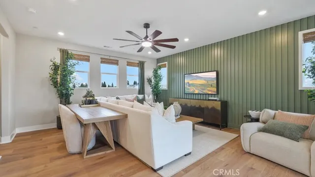 a living room with furniture a chandelier and a flat screen tv