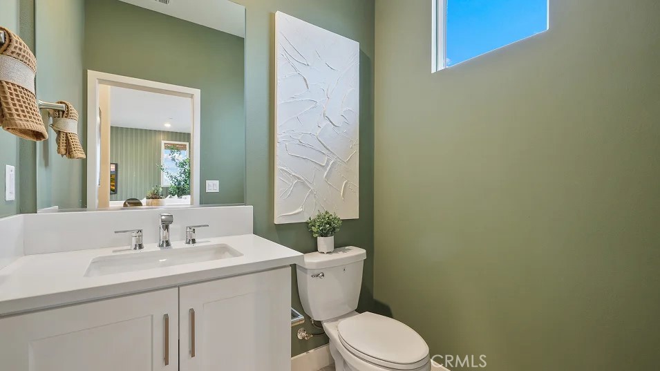 1022 Currant Road Fullerton, CA 92833 - Photo 6 of 25 a bathroom with a granite countertop toilet sink and mirror