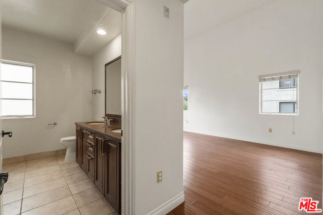 10765 Wilkins Avenue, Unit 8 Los Angeles, CA 90024 - Photo 12 of 33 an empty room with wooden floor and windows