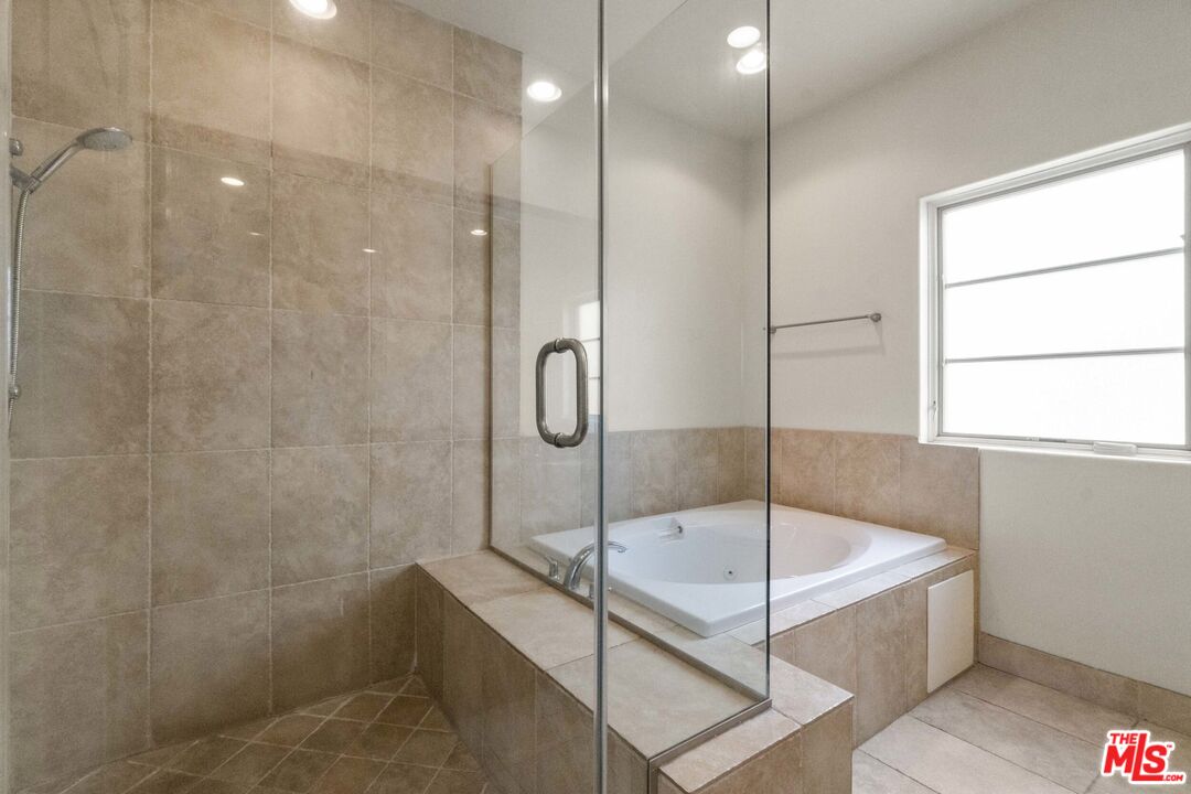 10765 Wilkins Avenue, Unit 8 Los Angeles, CA 90024 - Photo 17 of 33 a bathroom with a tub and shower
