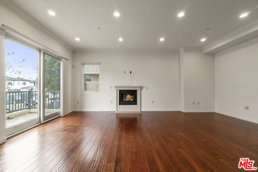 10765 Wilkins Avenue, Unit 8 Los Angeles, CA 90024 - Photo 7 of 33 a view of an empty room with wooden floor and a window