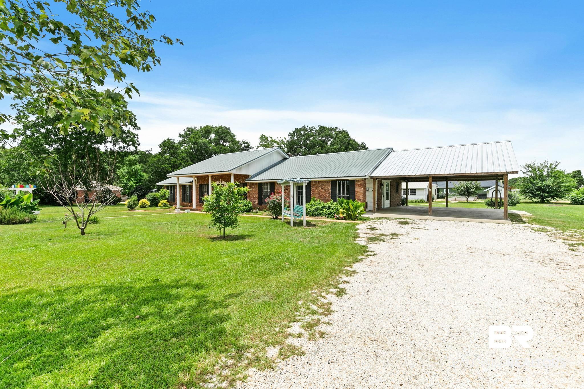3791 Robinsonville Road Atmore, AL 36502 - Photo 6 of 55 Brick ranch-style residence featuring a metal roof and an attached carport