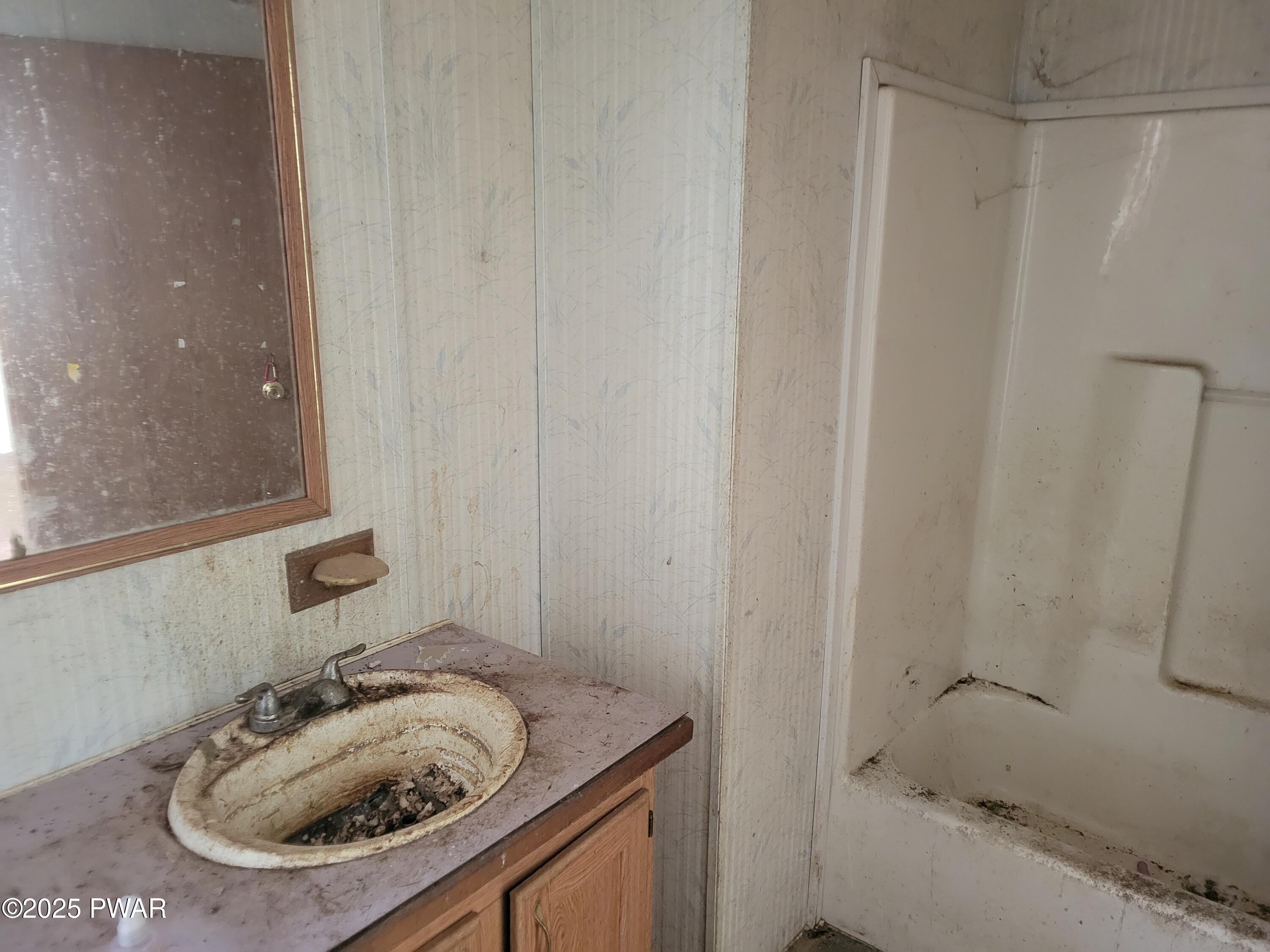 42 W Road Hawley, PA 18428 - Photo 7 of 11 a bathroom with a sink and a mirror