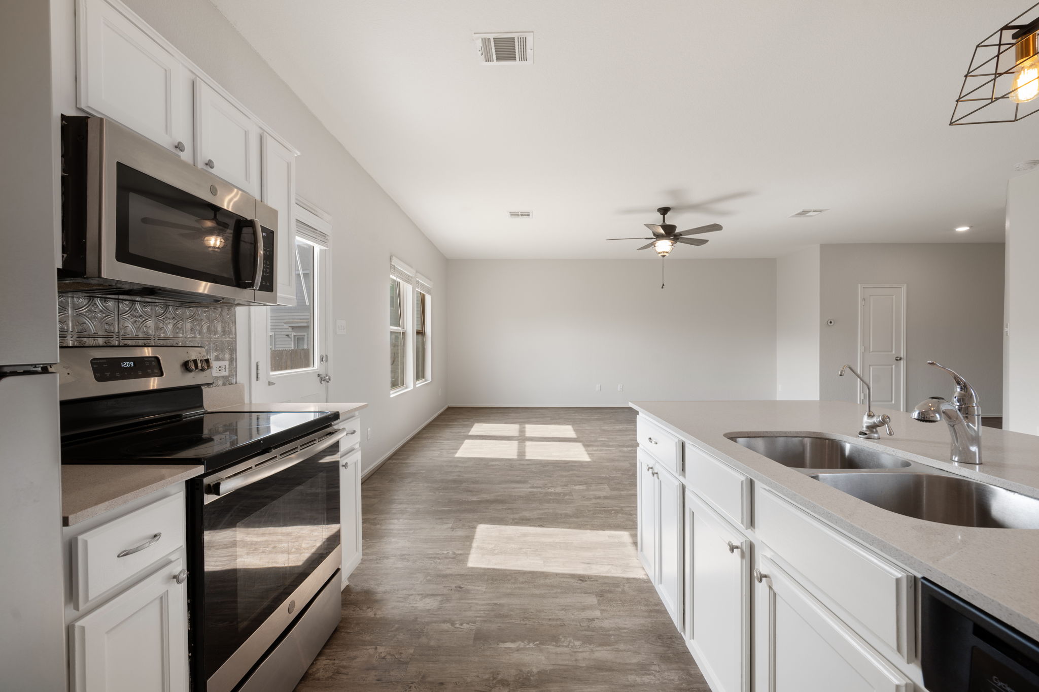 817 Circle Way Jarrell, TX 76537 - Photo 12 of 39 a kitchen with a sink stove and microwave