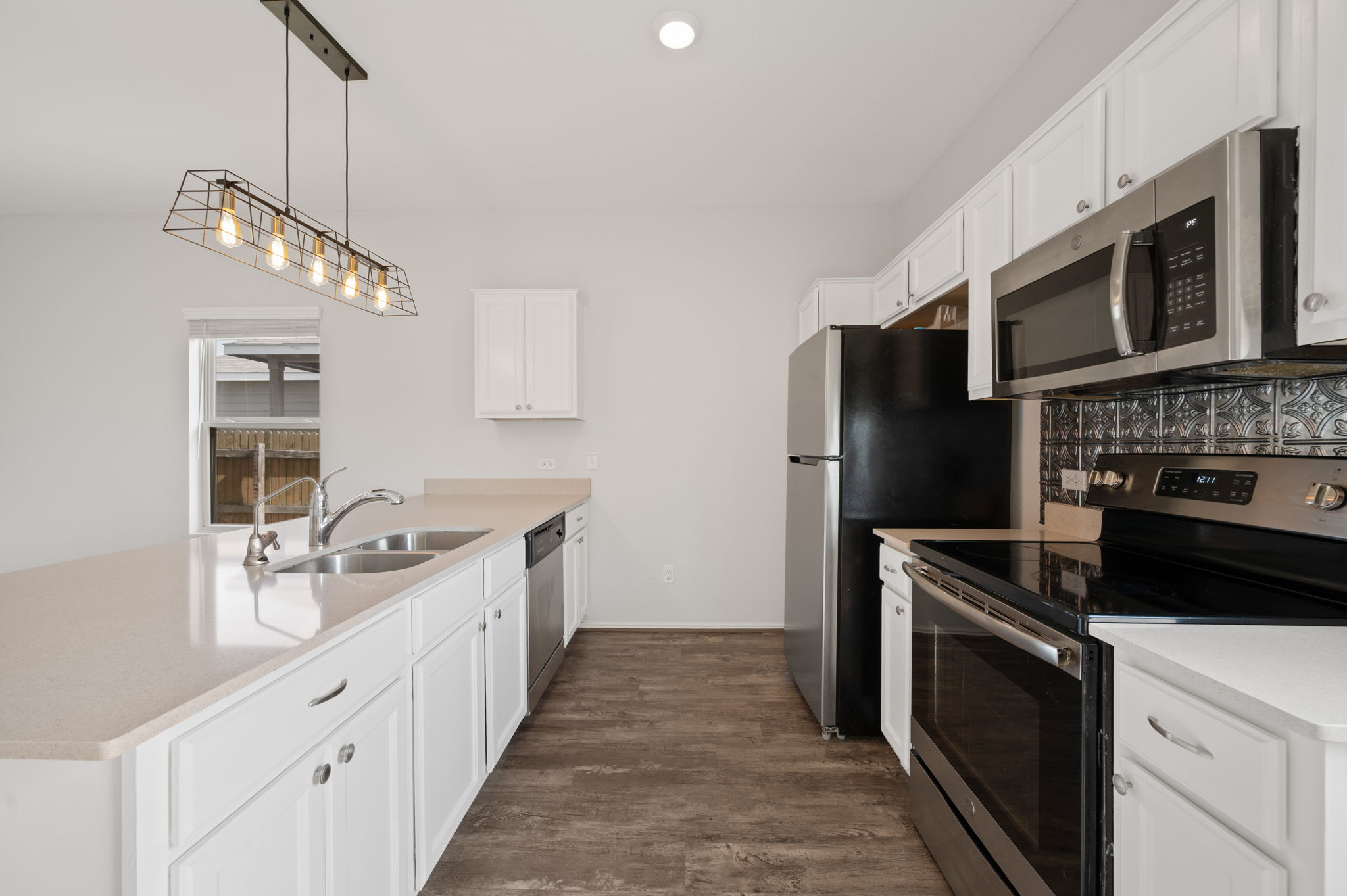 817 Circle Way Jarrell, TX 76537 - Photo 13 of 39 a kitchen with stainless steel appliances a stove oven a sink and a refrigerator