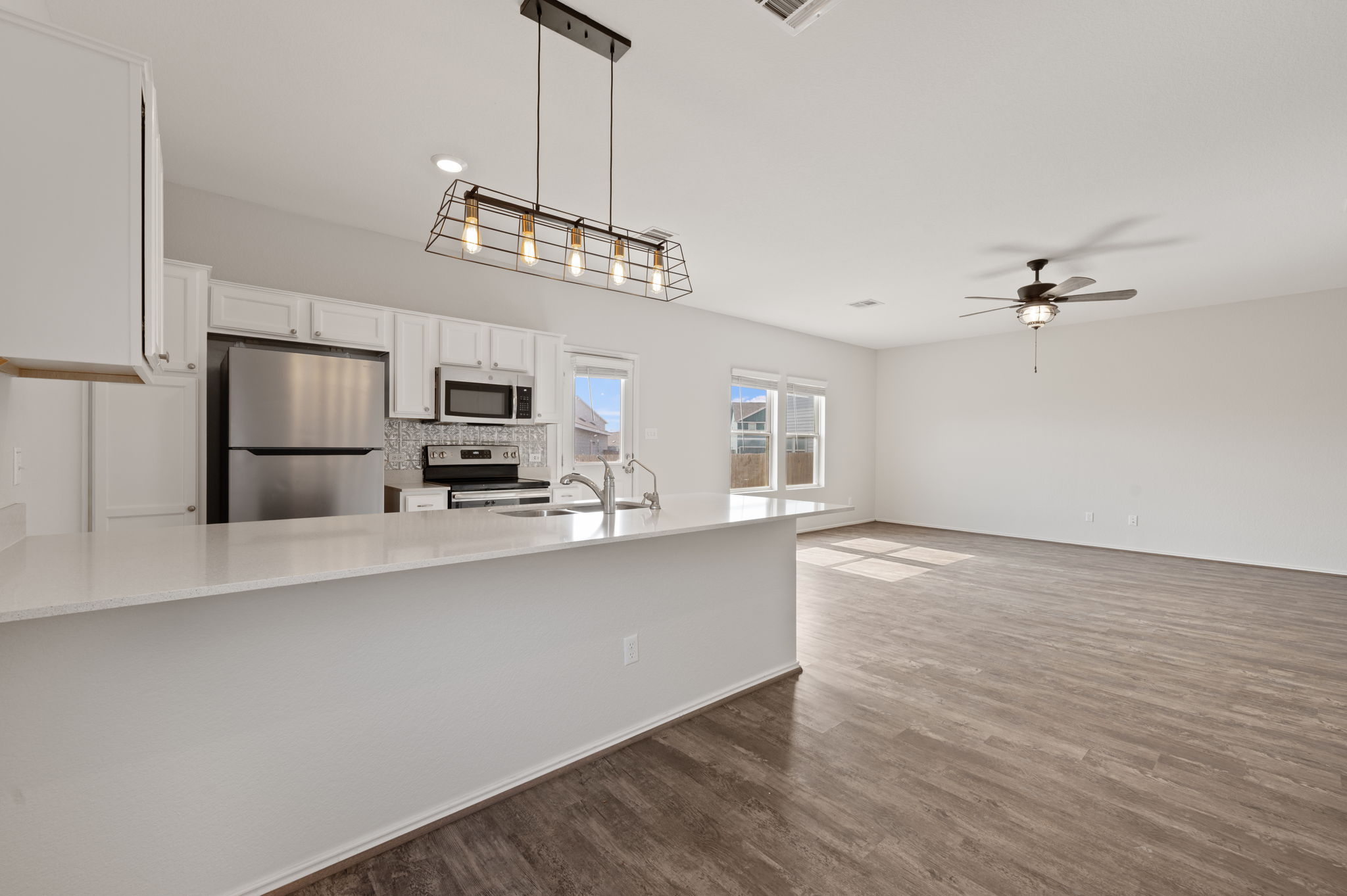 817 Circle Way Jarrell, TX 76537 - Photo 14 of 39 a view of a kitchen with stainless steel appliances granite countertop a refrigerator and a sink