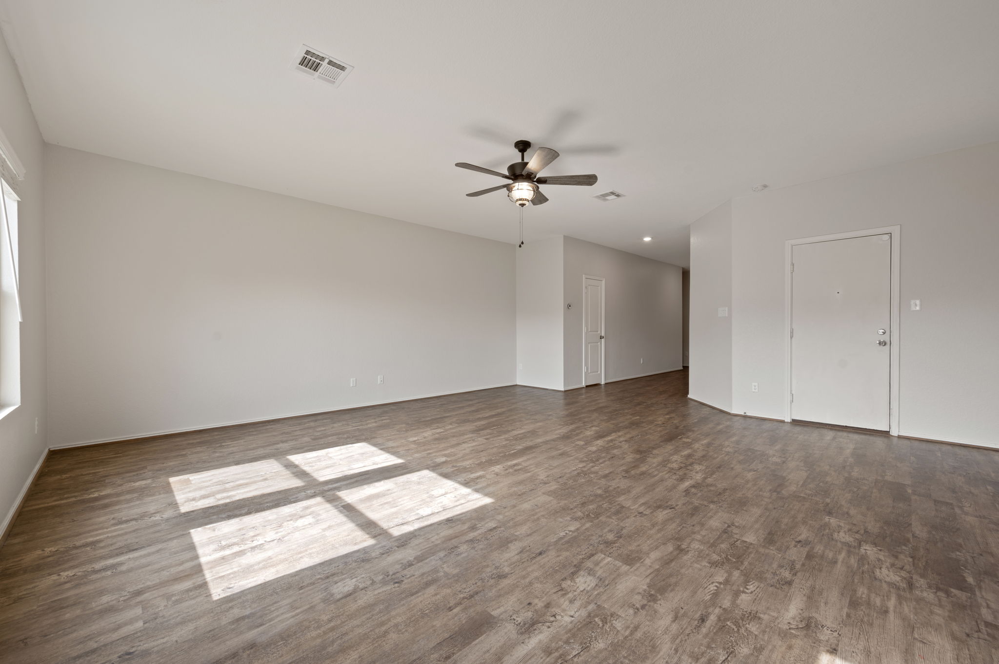 817 Circle Way Jarrell, TX 76537 - Photo 6 of 39 wooden floor in an empty room with a window