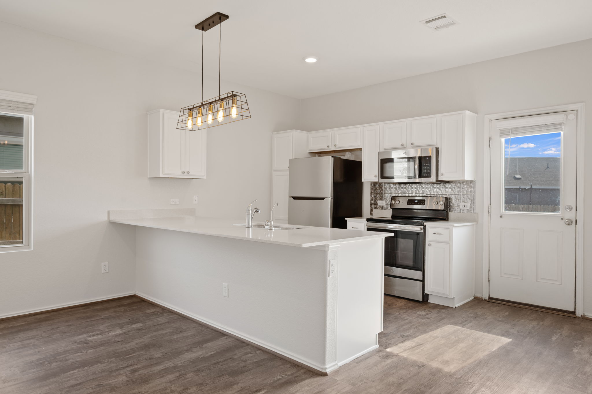 817 Circle Way Jarrell, TX 76537 - Photo 8 of 39 a kitchen with stainless steel appliances a refrigerator sink and stove