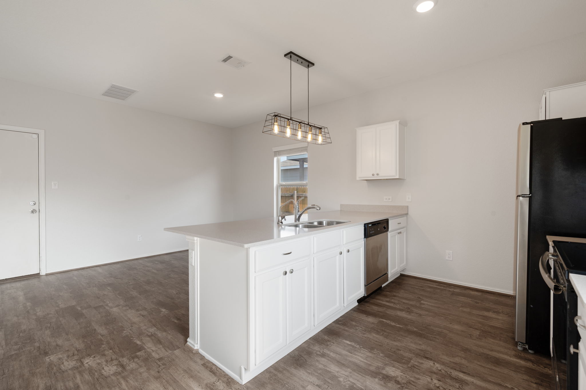 817 Circle Way Jarrell, TX 76537 - Photo 10 of 39 a kitchen that has a lot of cabinets and wooden floor