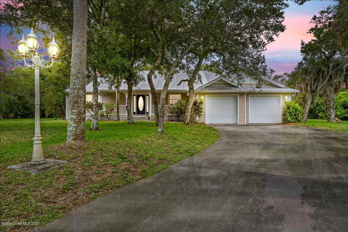 5551 Senne Road Micco, FL 32976 - Photo 1 of 37 a front view of a house with a yard and trees