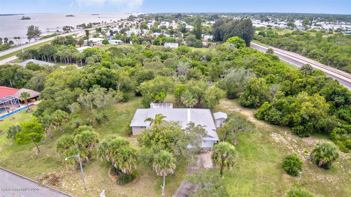 5551 Senne Road Micco, FL 32976 - Photo 26 of 37 an aerial view of residential houses with outdoor space and trees