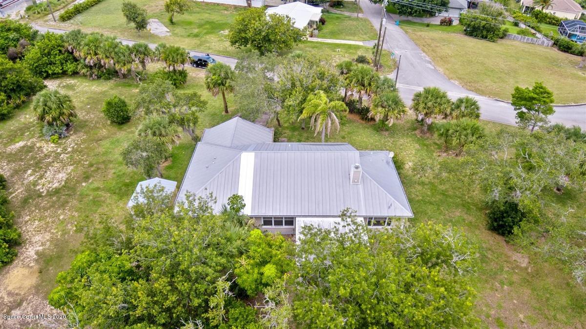 5551 Senne Road Micco, FL 32976 - Photo 30 of 37 an aerial view of a house with a yard and lake view