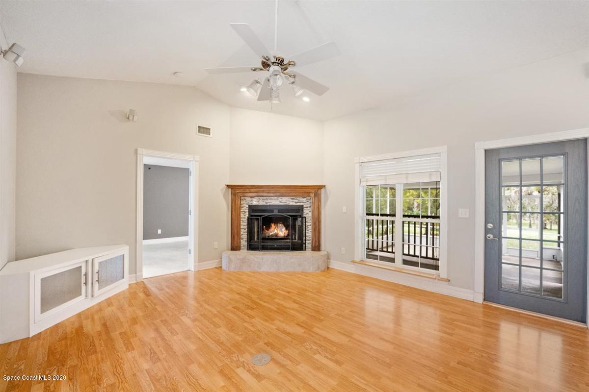 5551 Senne Road Micco, FL 32976 - Photo 5 of 37 a view of an empty room with a fireplace and a window