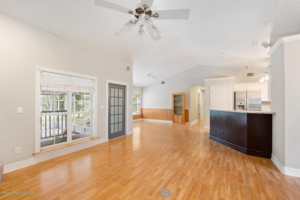 5551 Senne Road Micco, FL 32976 - Photo 6 of 37 a view of an empty room with wooden floor and a window